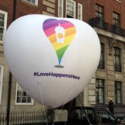 #LoveHappensHere giant white inflatable heart with rainbow design in street