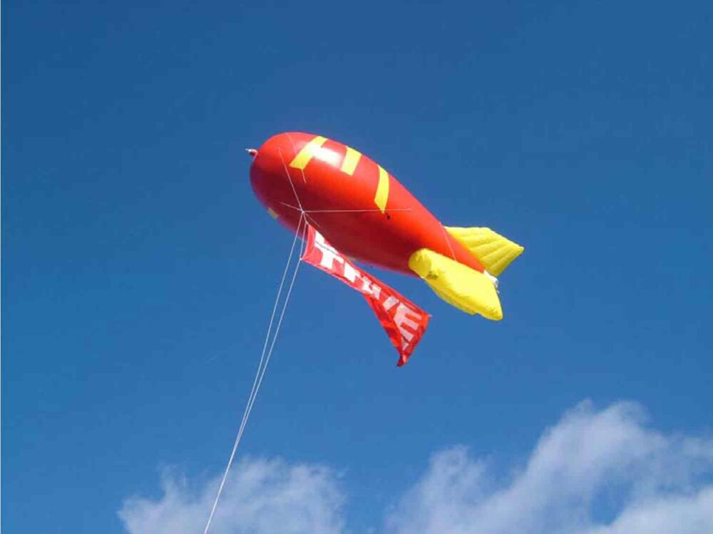 McDonalds site marker red blimp flying in blue sky