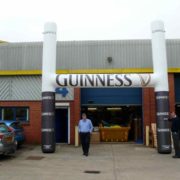 Man standing under inflatable Guinness rugby posts
