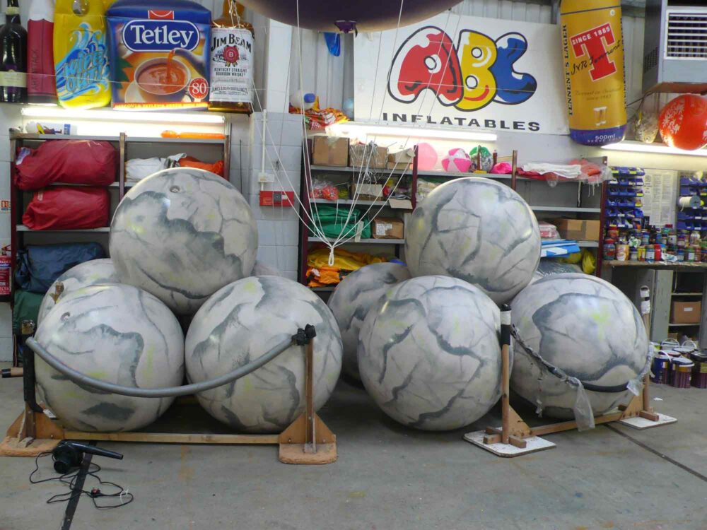 Giant push balls with grey boulder-like artwork