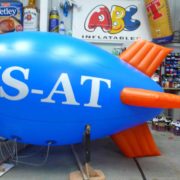 Blue airship with orange fins in ABC Inflatables workshop