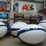 Partial artwork on 4 giant rugby balls in ABC Inflatables workshop