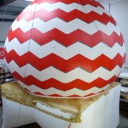 Man hand painting gold base to giant inflatable dome