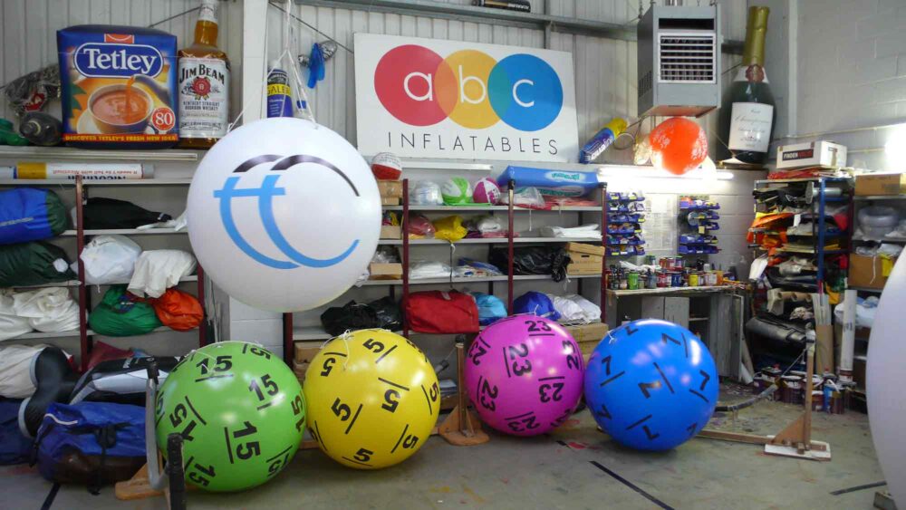 Green, yellow, purple and blue giant pushballs inflated in ABC's workshop