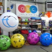 Green, yellow, purple and blue giant pushballs inflated in ABC's workshop