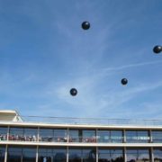 Flying punctuation marks above a pavilion - art installation