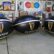 4 inflatable replica rugby balls with Guinness branding by ABC Inflatables