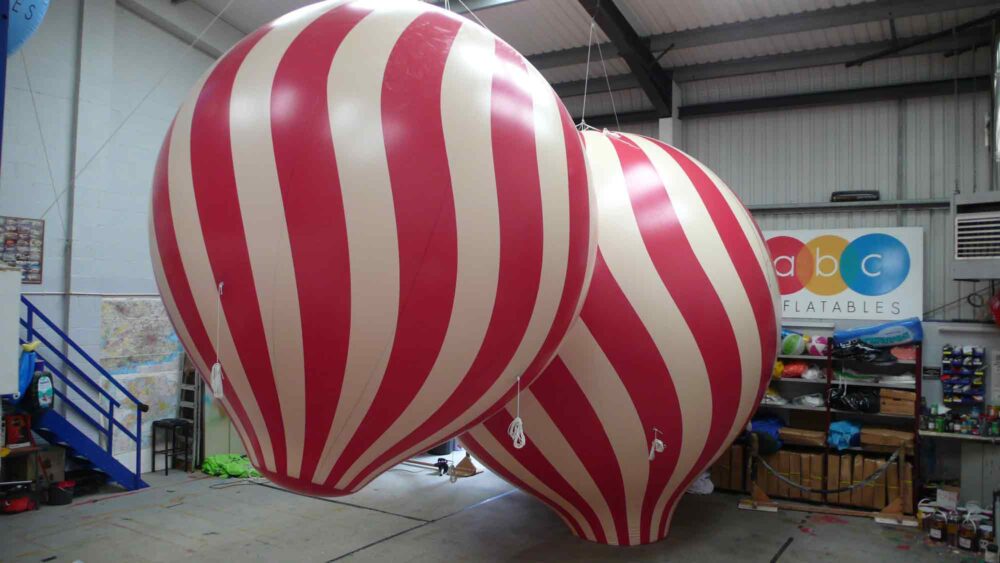 red and white striped balloon spheres