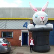 Lady standing by huge rabbit inflatable