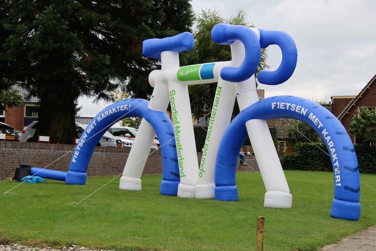 giant inflatable bike standing on grass