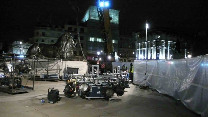 Lighting rig being set up next to one of Landseer's lion statues