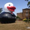 Hitman giant inflatable duck in a garden