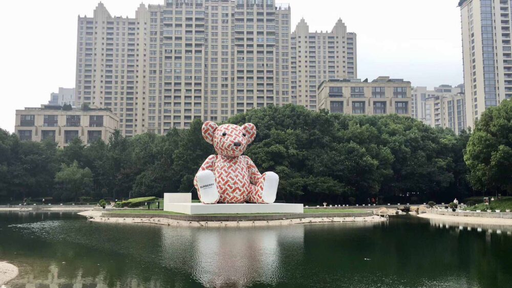 Giant Burberry Bear inflatable with water in front and skyline behind