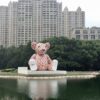 Giant Burberry Bear inflatable with water in front and skyline behind