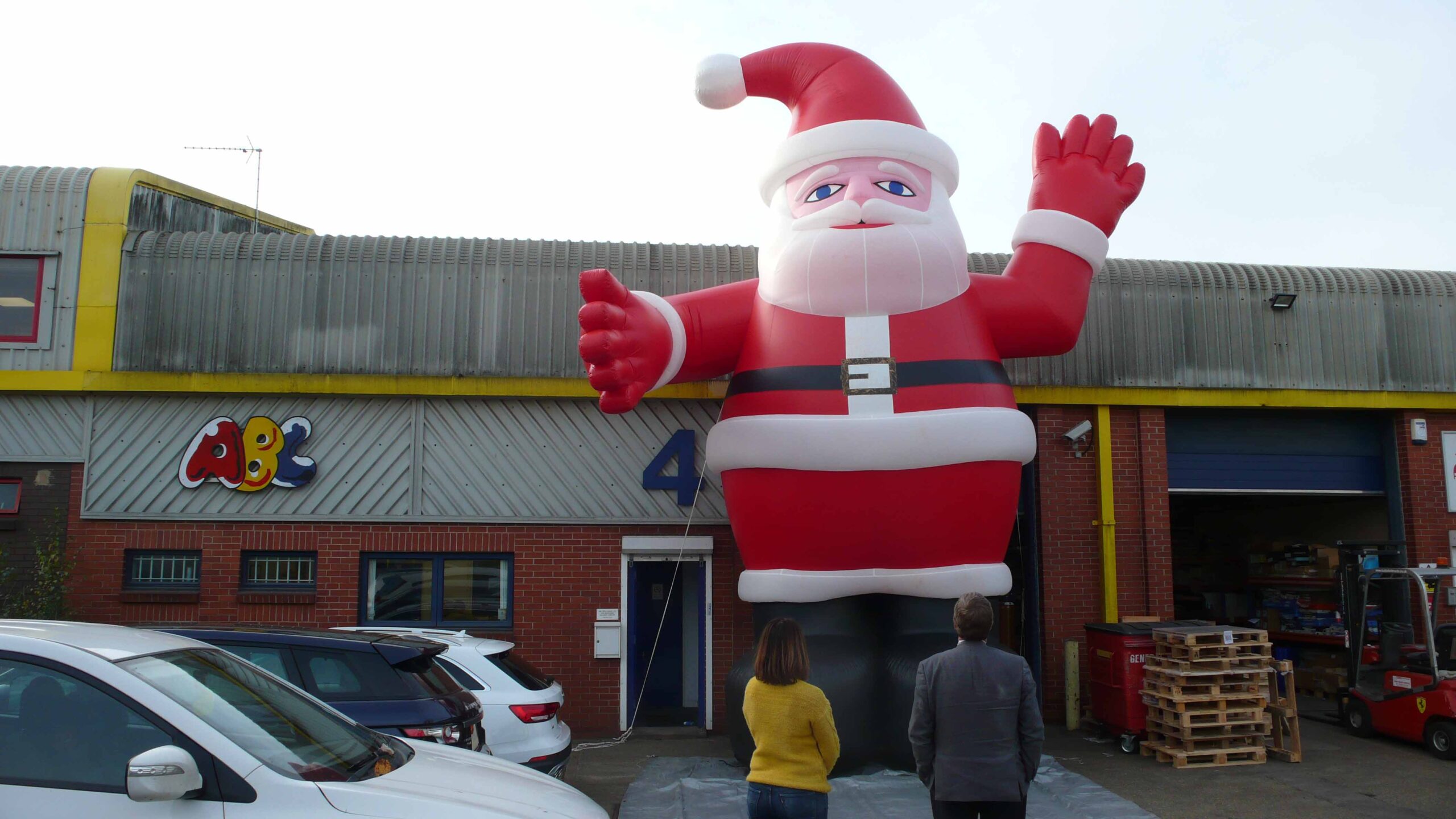 People looking at a giant inflatable Father Christmas