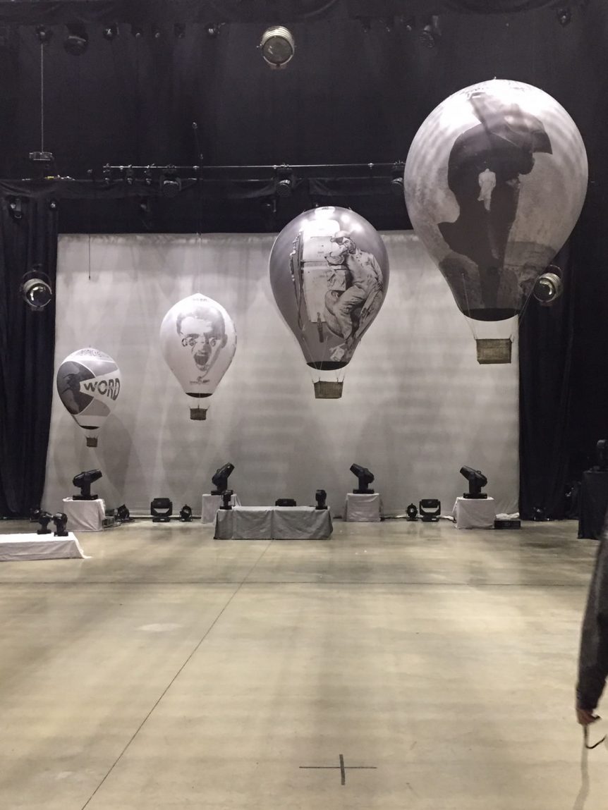 4 printed balloons above stage for Mike & the Mechanics