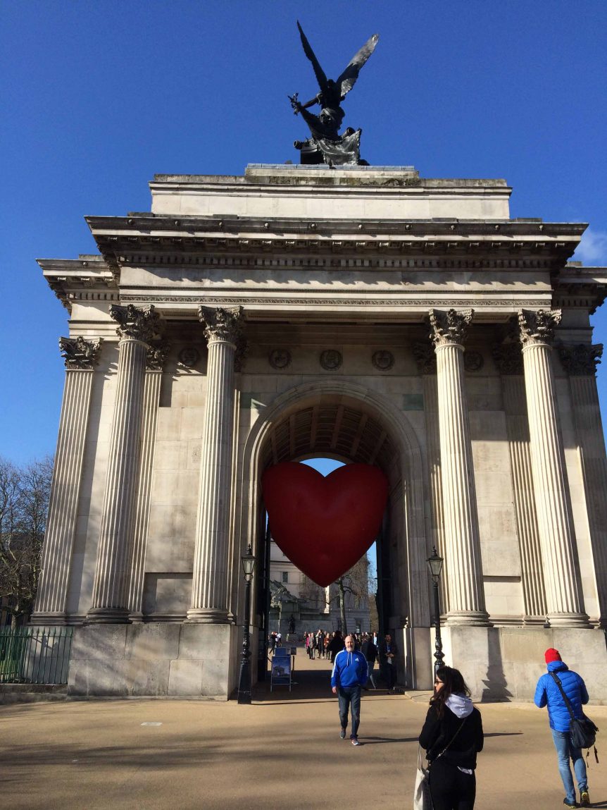 People in front of Wellington Arch with inflatable heart in the arch